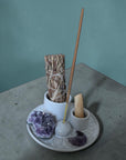 incense burner with built-in holders for sage, palo santo, and incense sticks.