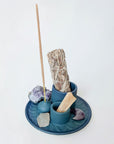 Blue incense burner with built-in holders for sage, palo santo, and incense sticks.