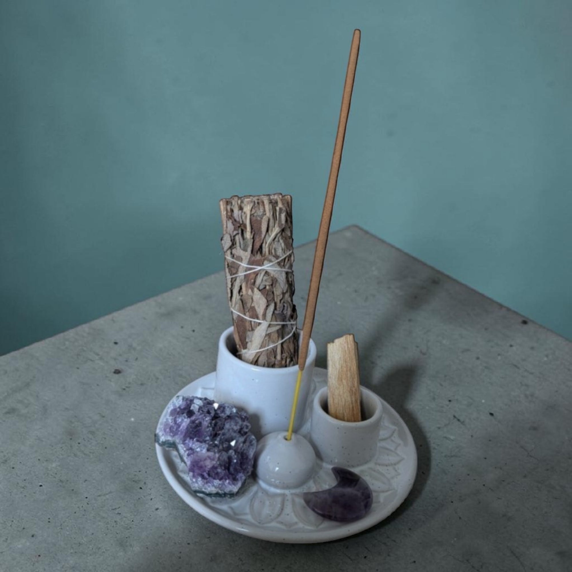 incense burner with built-in holders for sage, palo santo, and incense sticks.