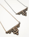 Bronze ornate necklace on a white background