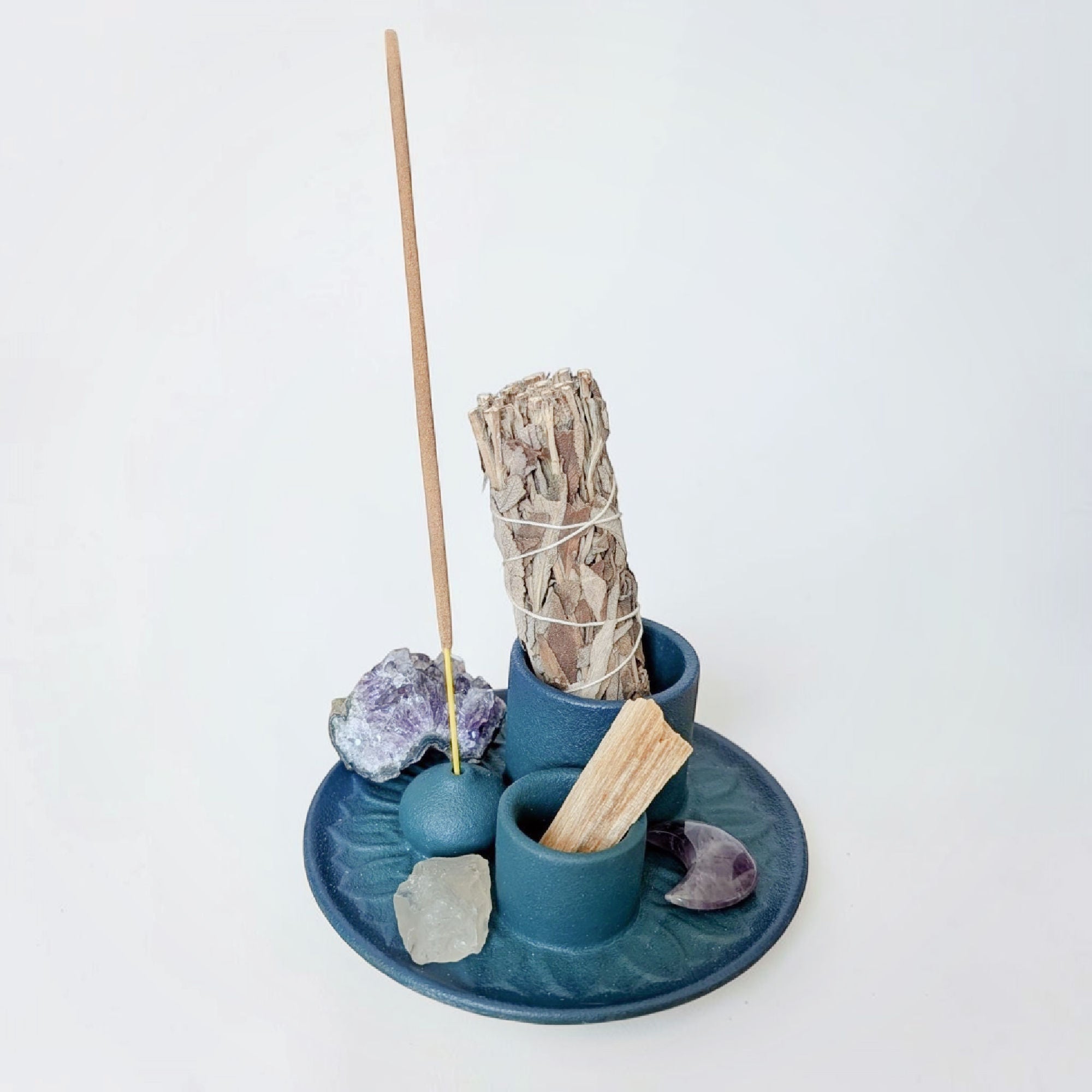 Blue incense burner with built-in holders for sage, palo santo, and incense sticks.