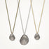 Three shell pendant necklaces on gold, silver, and bronze chains against a white background.