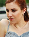 girl wearing wishbone necklace and earrings